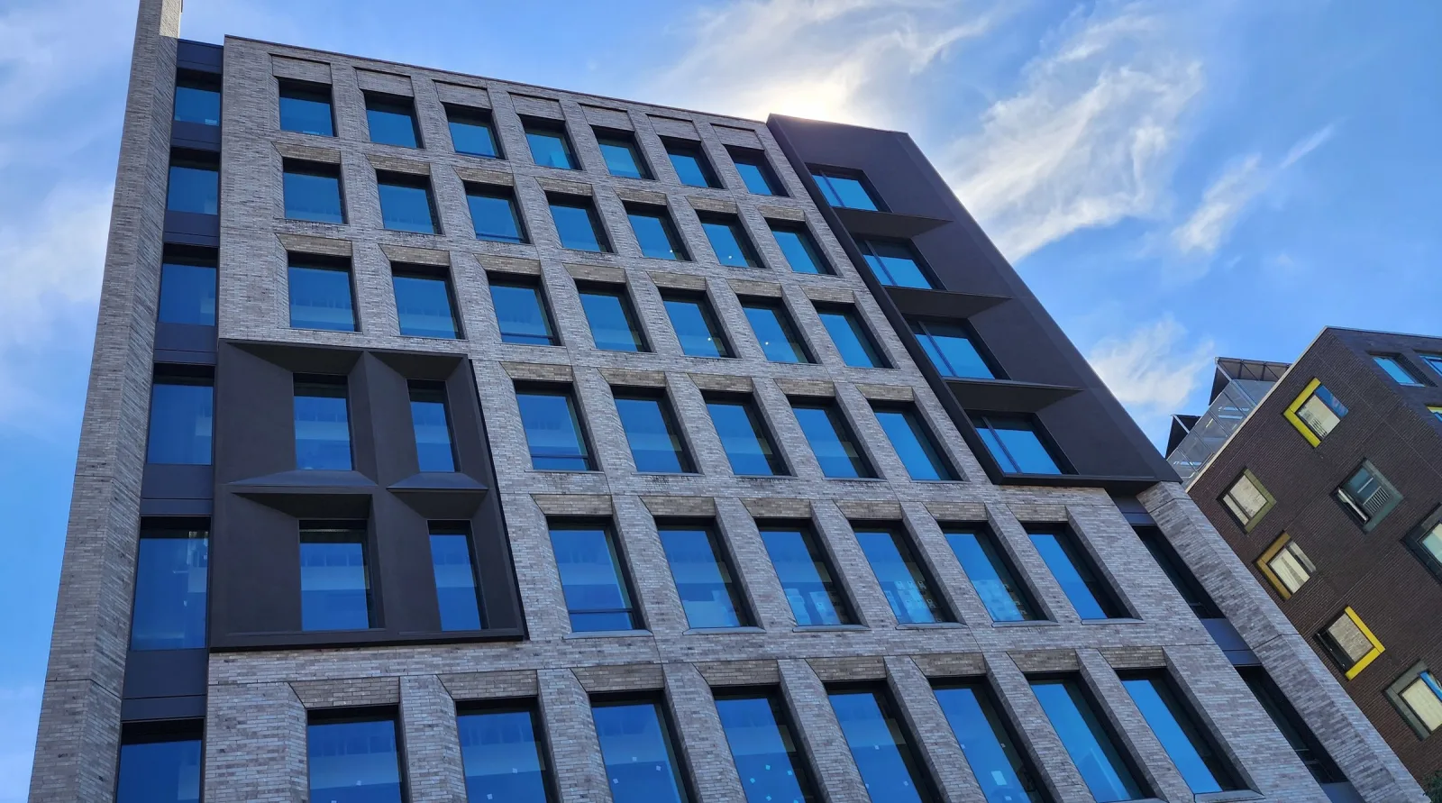 Health Department HQ brick and glass facade from below