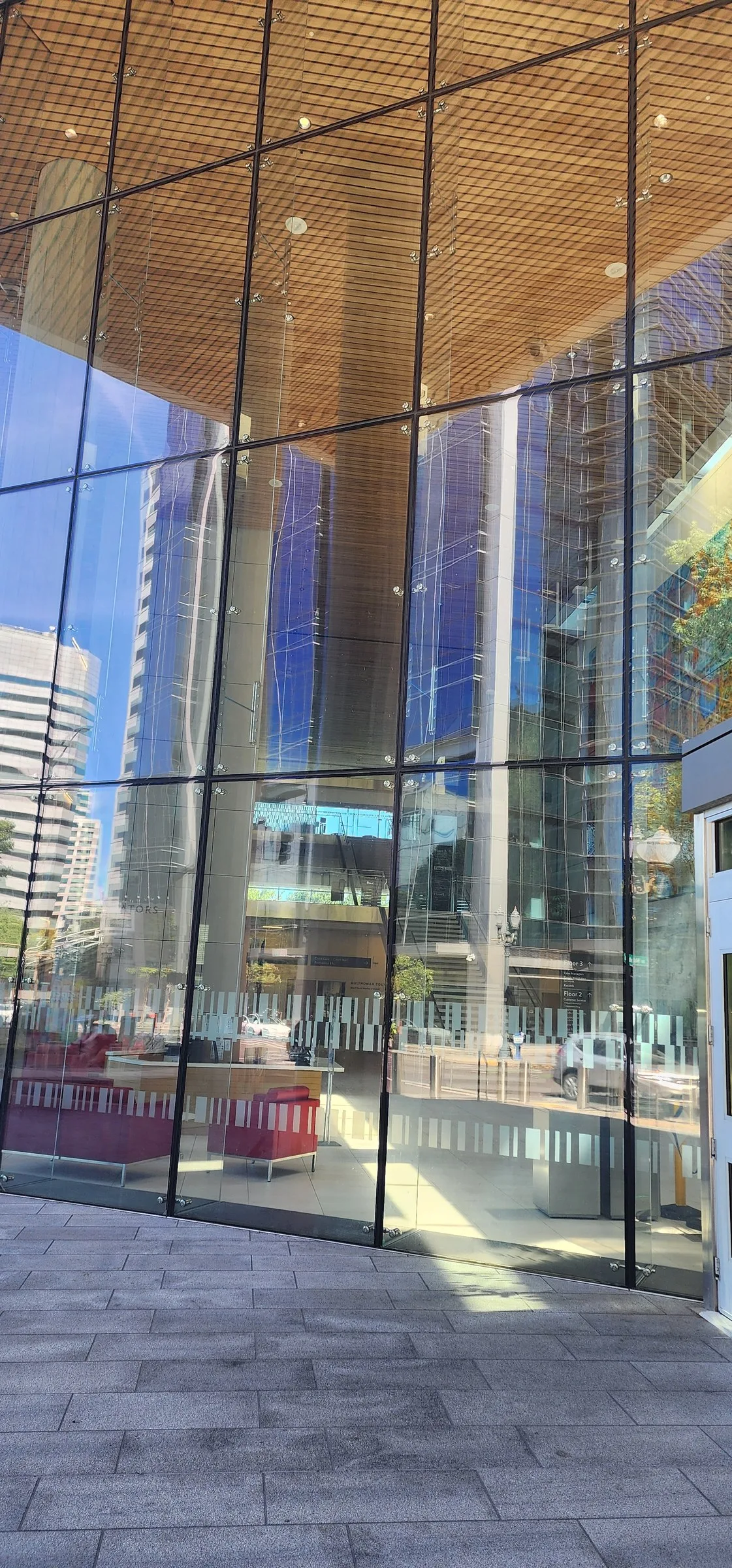 Full-height glass wall of the courthouse lobby