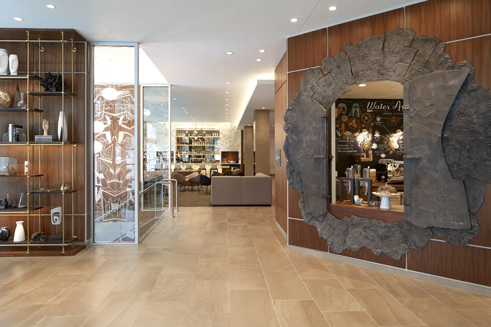 AC Hotel Portland lobby with a carved stone feature wall